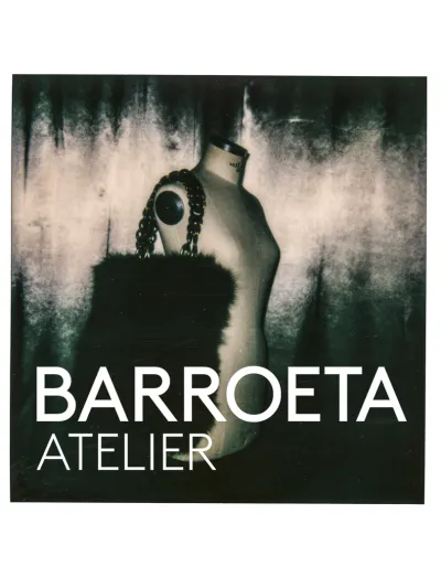 Sepia-toned image of a dressmaker's mannequin with a fur stole and 'Barroeta Atelier' text